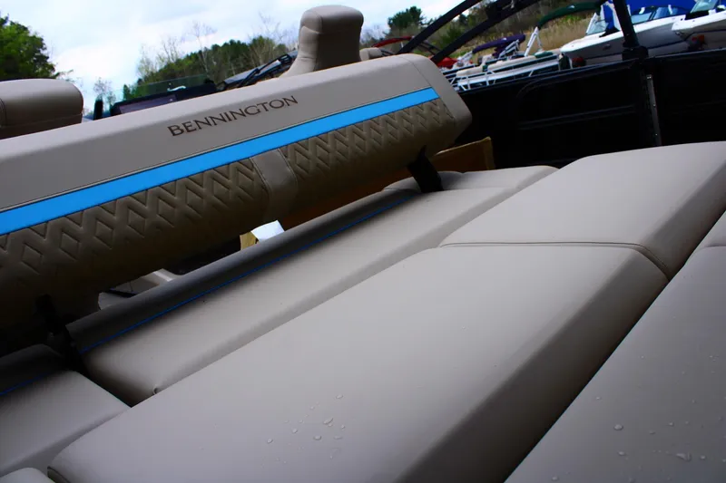 Slide: The Image of Bennington 22MSB 2026 boat interior with beige seating and blue accents. - 3