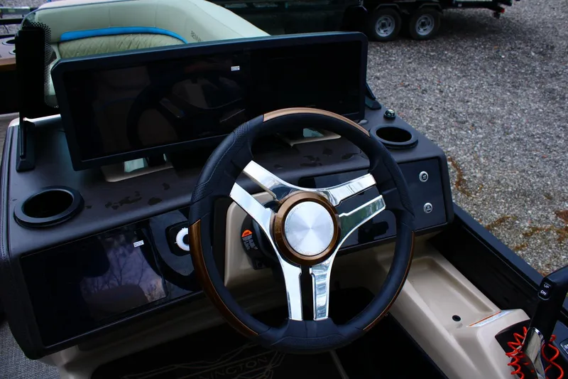 Slide: The Image of Steering wheel and dashboard of 2026 Bennington 22MSB boat, featuring modern controls. - 4