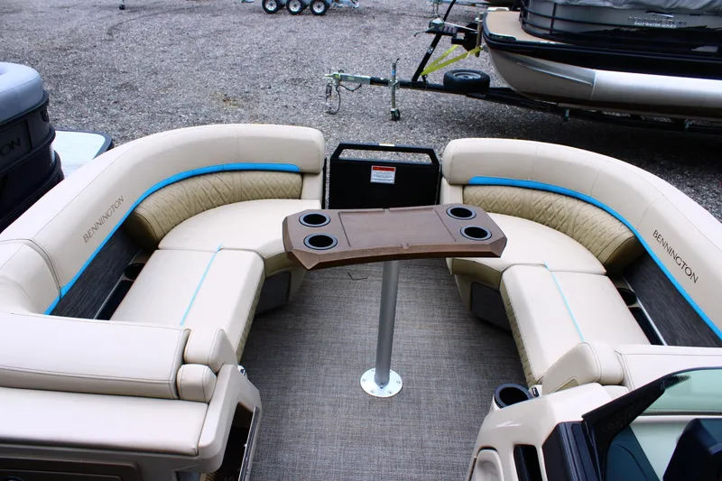 Slide: The Image of Luxurious seating area on a 2026 Bennington 22MSB pontoon boat with table and cup holders. - 6