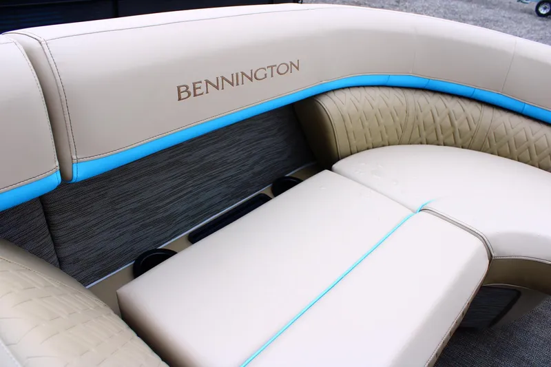 Slide: The Image of Luxurious seating on 2026 Bennington 22MSB boat with beige upholstery and blue accents. - 8