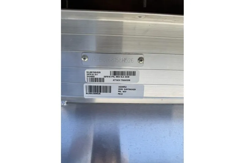 Slide: The Image of 2026 Sun Tracker Party Barge 18 DLX identification plate with serial numbers and barcodes. - 12