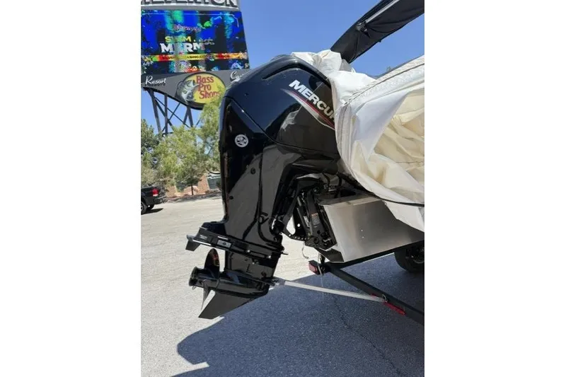 Slide: The Image of 2026 Sun Tracker Party Barge 18 DLX with Mercury outboard motor in parking lot. - 6