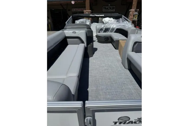 Slide: The Image of 2026 Sun Tracker Party Barge 18 DLX interior with gray seating and spacious layout. - 9