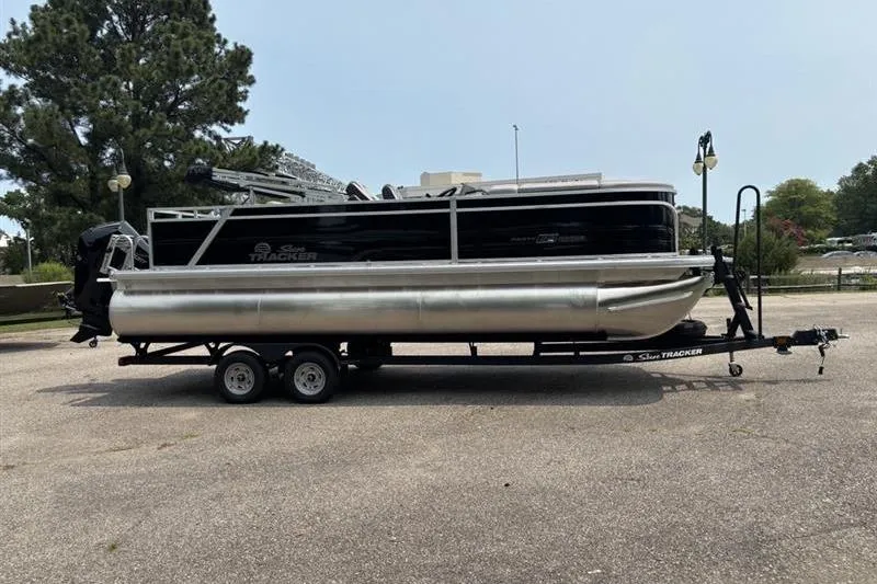 Slide: The Image of 2026 Sun Tracker Party Barge 22 RF XP3 pontoon boat on trailer, parked outdoors. - 4