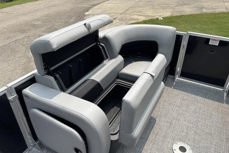 Slide: The Image of 2026 Sun Tracker Party Barge 22 RF XP3 with open storage compartments and gray seating. - 8