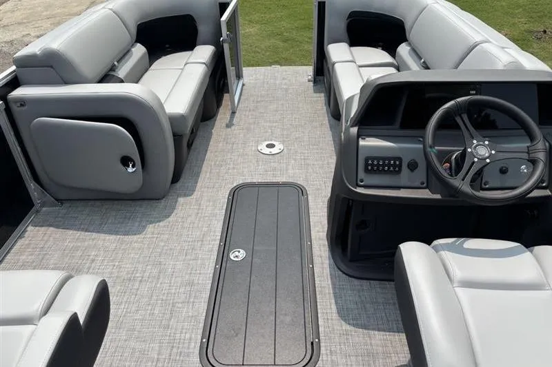 Slide: The Image of 2026 Sun Tracker Party Barge 22 RF XP3 interior with gray seating and steering console. - 15