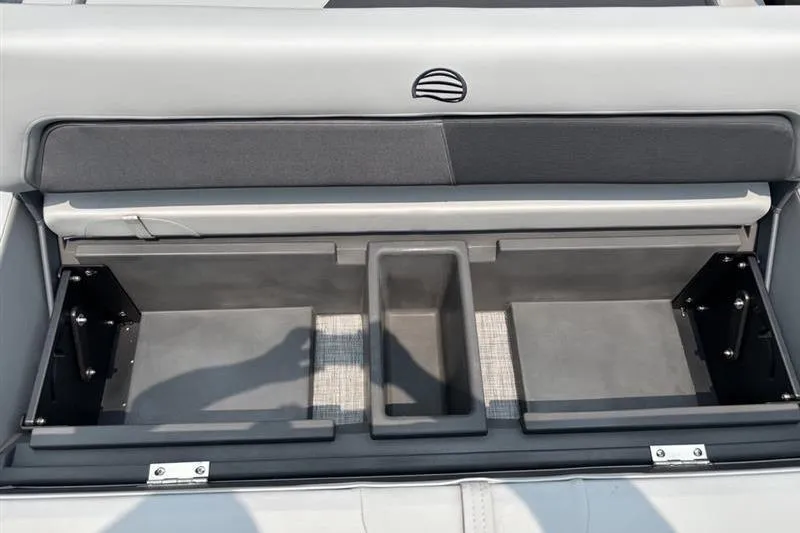 Slide: The Image of 2026 Sun Tracker Party Barge 22 RF XP3 storage compartment with open lid and organized interior. - 19