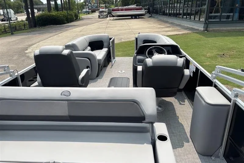 Slide: The Image of 2026 Sun Tracker Party Barge 22 RF XP3 interior with plush seating and steering console. - 17
