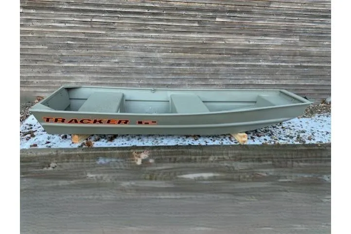 The Image of 2026 Tracker Grizzly 12 Jon boat displayed outdoors on wooden supports. - 0