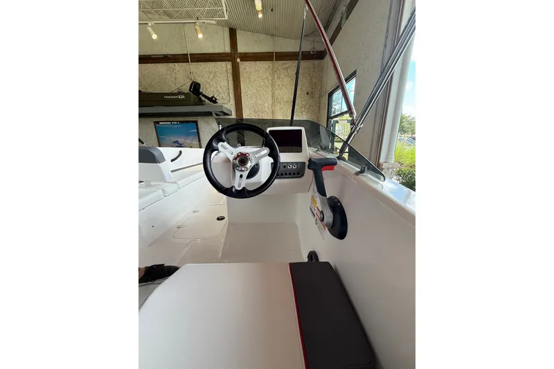Slide: The Image of 2026 Tahoe T16 boat interior with steering wheel and control panel in showroom. - 7