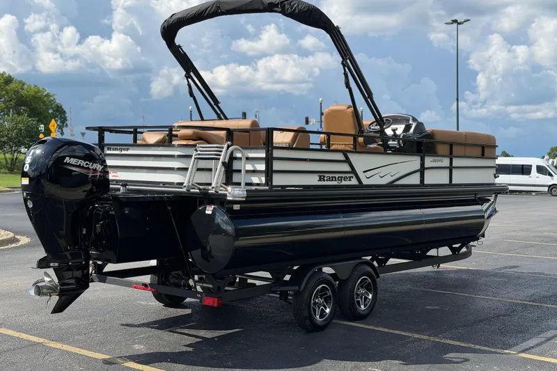 Slide: The Image of 2026 Ranger 223FC pontoon boat with Mercury engine on trailer in parking lot. - 6