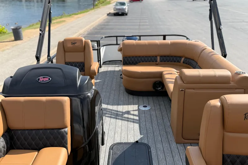 Slide: The Image of 2026 Ranger 223FC boat with tan seating and sleek design by the water. - 13