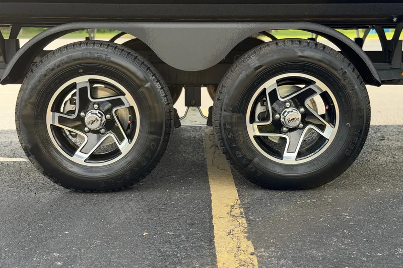Slide: The Image of 2026 Ranger 223FC wheels with Kenda Karrier KR35 tires on asphalt. - 12
