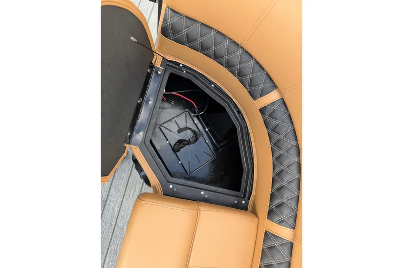 Slide: The Image of Ranger 223FC 2026 boat seat storage compartment with tan and black quilted upholstery. - 25