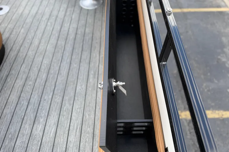 Slide: The Image of Open storage compartment on Ranger 223FC boat, showcasing sleek design and secure latch. - 20