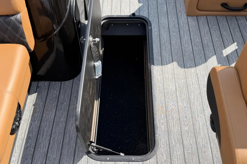 Slide: The Image of Open storage compartment on 2026 Ranger 223FC boat with wood-patterned flooring. - 14