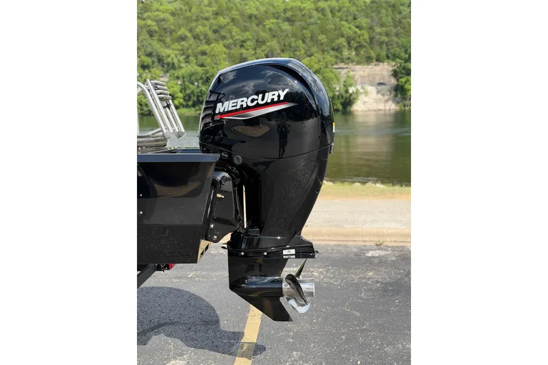 Slide: The Image of Outboard motor on a 2026 Ranger 223FC boat, parked near a scenic river. - 3