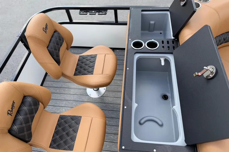 Slide: The Image of 2026 Ranger 223FC boat interior with tan and black seating, sink, and cup holders. - 26