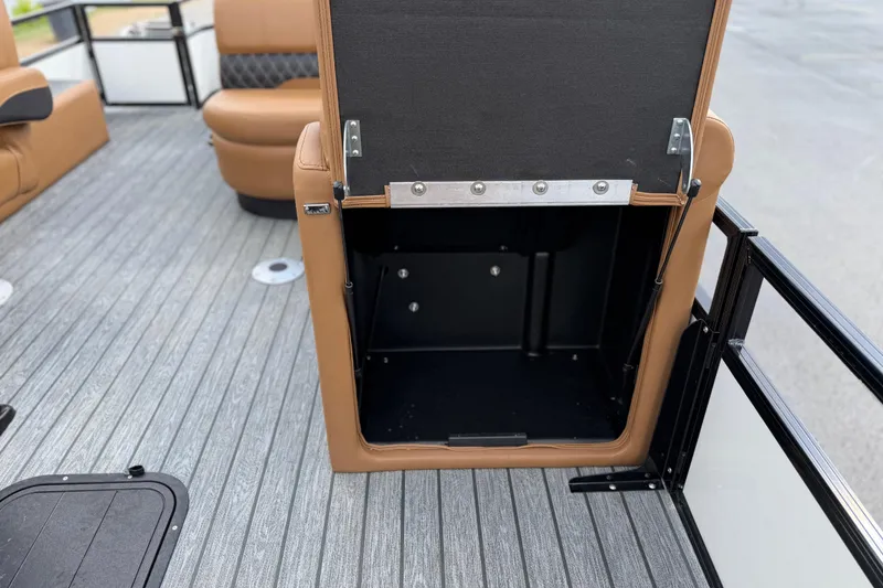 Slide: The Image of Open storage compartment on 2026 Ranger 223FC boat with brown seating and gray flooring. - 22