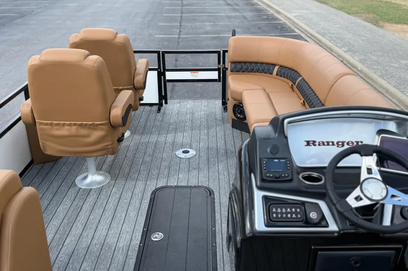 Slide: The Image of 2026 Ranger 223FC boat interior with tan seating and modern dashboard. - 16