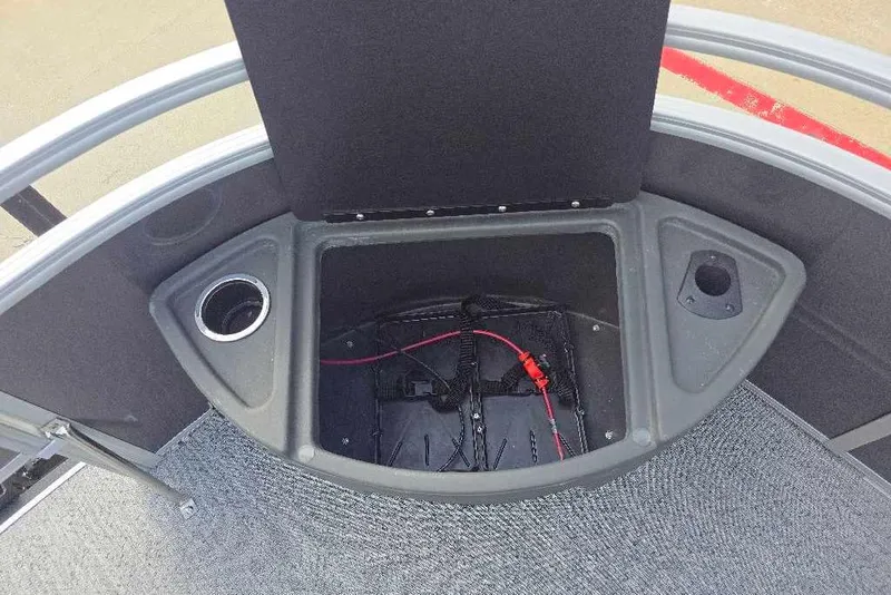 Slide: The Image of 2026 Sun Tracker Fishin' Barge 20 DLX storage compartment with cup holder and wiring. - 10