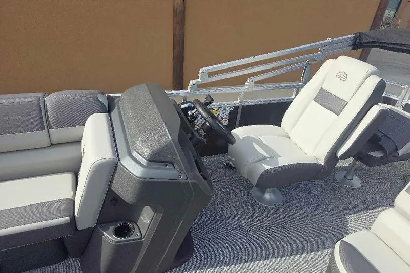 Slide: The Image of 2026 Sun Tracker Fishin' Barge 20 DLX interior with plush seating and modern helm. - 14