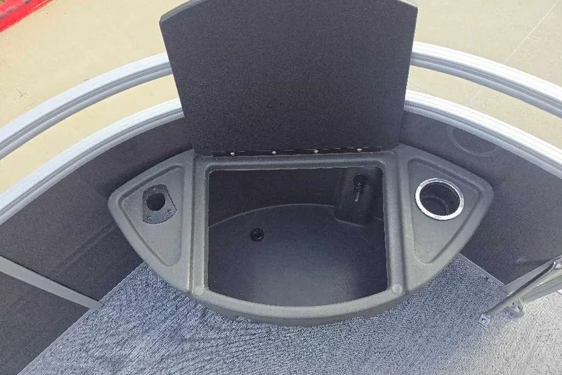 Slide: The Image of 2026 Sun Tracker Fishin' Barge 20 DLX boat interior with storage and cup holder. - 11