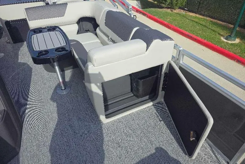 Slide: The Image of 2026 Sun Tracker Fishin' Barge 20 DLX interior with seating and table. - 8