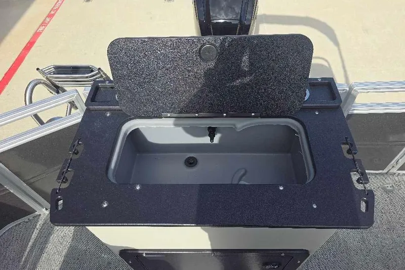 Slide: The Image of 2026 Sun Tracker Fishin' Barge 20 DLX livewell with open lid, showcasing interior. - 16
