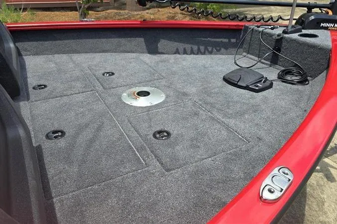 Slide: The Image of 2026 Tracker Pro Guide V-16 WT boat deck with red trim and fishing equipment. - 8