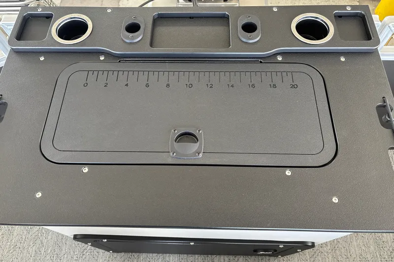 Slide: The Image of 2026 Sun Tracker Fishin' Barge 20 DLX fishing station with built-in ruler and cup holders. - 26