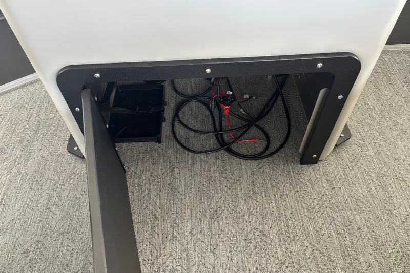 Slide: The Image of 2026 Sun Tracker Fishin' Barge 20 DLX battery compartment with cables and wiring. - 23