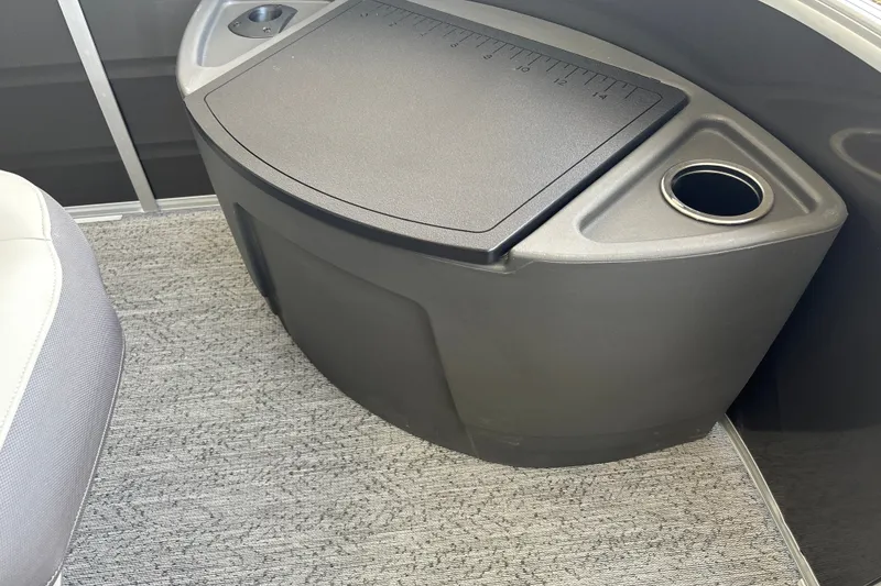 Slide: The Image of 2026 Sun Tracker Fishin' Barge 20 DLX interior with cup holder and storage compartment. - 31