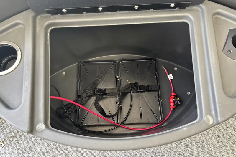 Slide: The Image of Battery compartment of 2026 Sun Tracker Fishin' Barge 20 DLX with wiring and straps. - 35