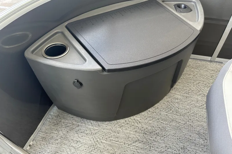Slide: The Image of 2026 Sun Tracker Fishin' Barge 20 DLX interior with cup holder and storage compartment. - 30