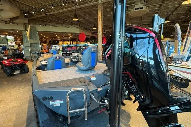 Slide: The Image of 2026 Ranger RT188P boat displayed indoors with blue seats and powerful engine. - 3