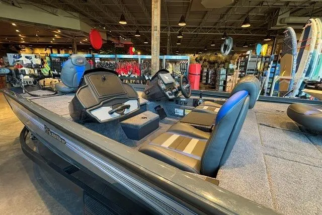 Slide: The Image of 2026 Ranger RT188P fishing boat interior with seating and control panel in showroom. - 4
