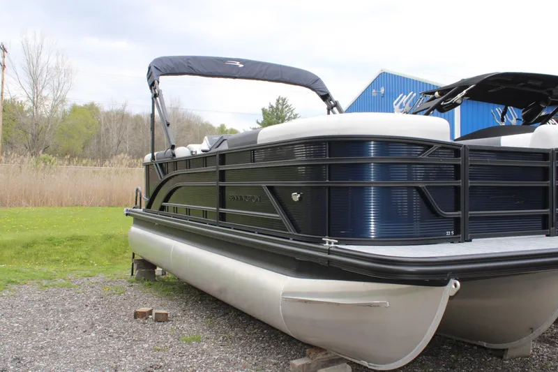 The Image of 2026 Bennington 22 SSRSF pontoon boat with sleek design, parked outdoors. - 1