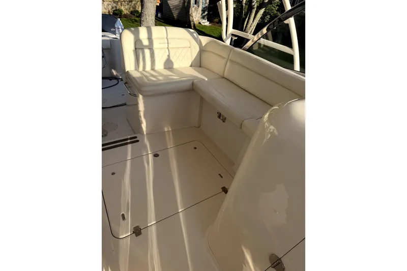 Slide: The Image of 2017 Grady White Freedom 335 boat interior with cream seating and deck. - 12