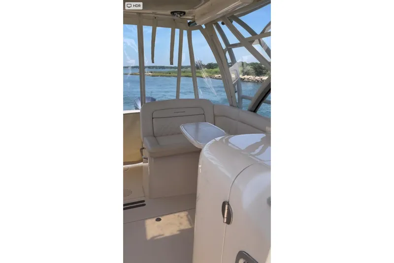 Slide: The Image of Interior view of 2017 Grady White Freedom 335 boat with seating and water backdrop. - 13
