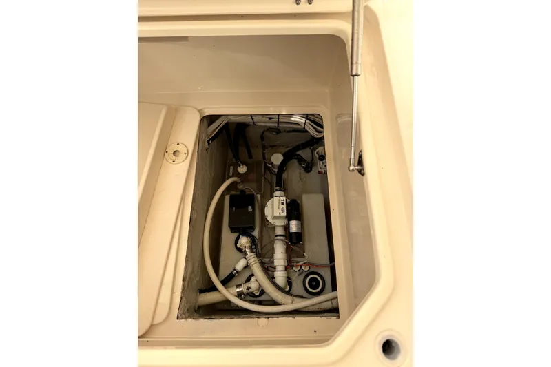Slide: The Image of 2017 Grady White Freedom 335 boat compartment with visible plumbing and wiring components. - 16
