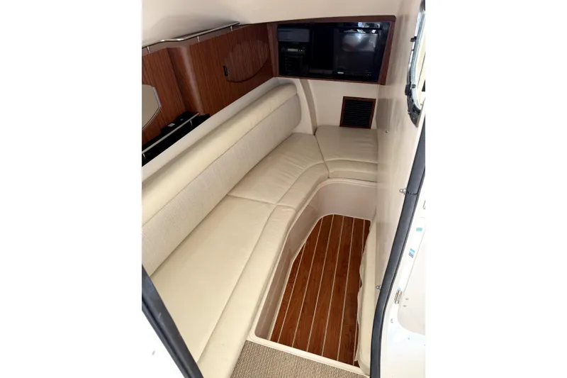 Slide: The Image of 2017 Grady White Freedom 335 cabin interior with beige seating and wood flooring. - 19