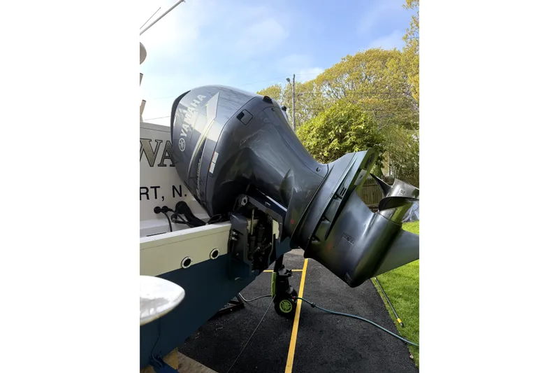 Slide: The Image of 2017 Grady White Freedom 335 boat with Yamaha outboard motor, parked on a driveway. - 20