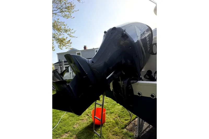 Slide: The Image of 2017 Grady White Freedom 335 boat engine, parked on grass with a red bucket nearby. - 22