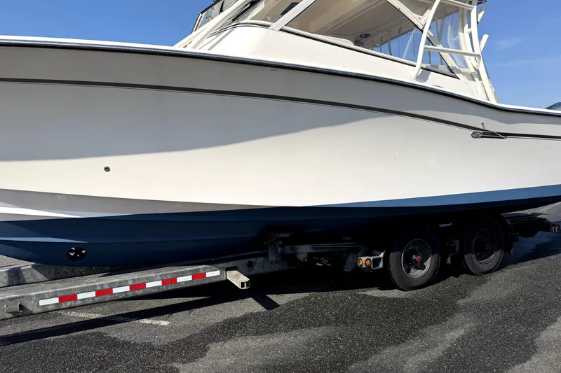 Slide: The Image of 2017 Grady White Freedom 335 boat on trailer, side view under clear blue sky. - 3