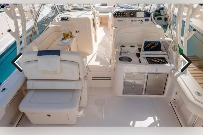 Slide: The Image of 2017 Grady White Freedom 335 boat interior with seating, grill, and refreshments. - 6