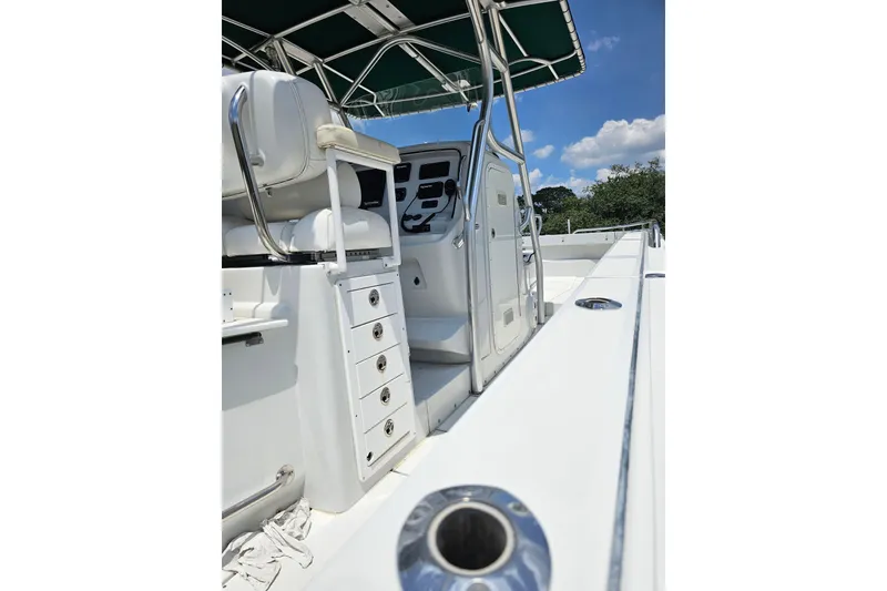 Slide: The Image of 2007 Glacier Bay 3065 Canyon Runner, Starboard side shot of the console and the helm seating with compartments for tackle. - 22