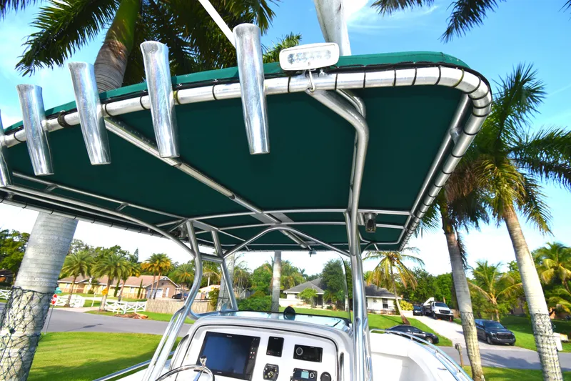 Slide: The Image of 2007 Glacier Bay 3065 Canyon Runner boat with canopy, surrounded by palm trees. - 24