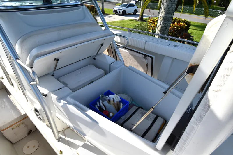 Slide: The Image of 2007 Glacier Bay 3065 Canyon Runner boat storage compartments with cleaning supplies and equipment. - 27