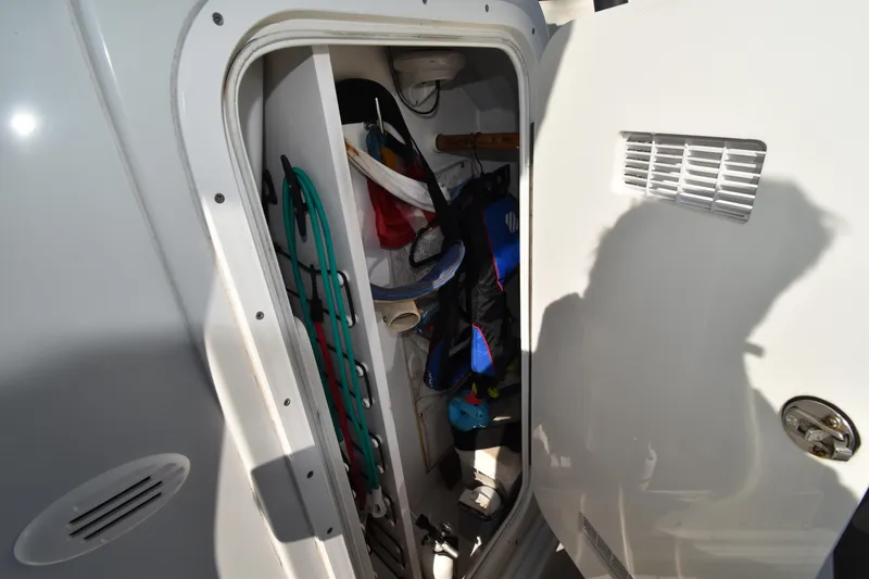 Slide: The Image of Storage compartment of 2007 Glacier Bay 3065 Canyon Runner boat, containing various equipment. - 31